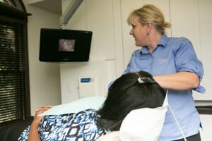 Fixari Family Dental assistant with a patient