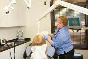 Fixari Family Dental hygienist performing teeth whitening on a patient