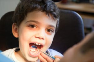 child getting teeth checked by the dentist