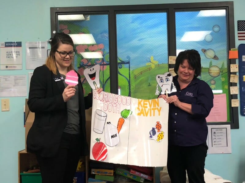 staff teaching children about dental care